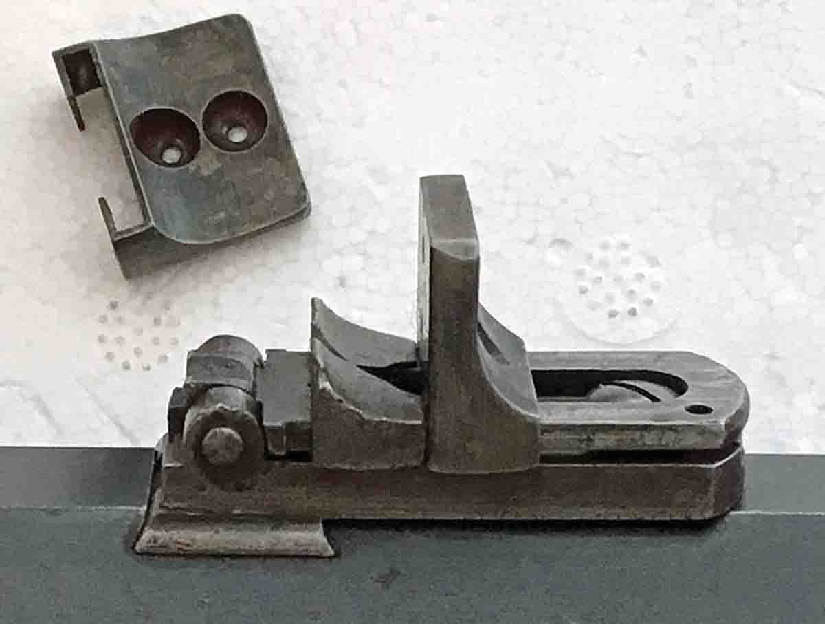 This is the rear sight, which is a ladder sight. Note that the second taller slider on the ladder is actually a peep sight. Above on the white background is an identical peep slider and you can see two peep holes in it, one for 75 yards and one for 125 yards. The peep sight was used for this test.3